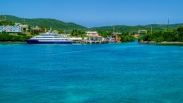 Docked ferry in sapphire blue bay by the coast, Culebra, Puerto Rico  Aerial Stock Photos | AX102_149.0000236F