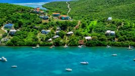 Island homes overlooking boats in the water in Culebra, Puerto Rico Aerial Stock Photos | AX102_156.0000000F