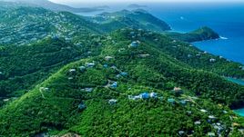Hilltop island homes over looking the blue ocean waters by the coast, East End, St Thomas  Aerial Stock Photos | AX102_259.0000000F