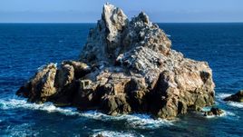 A jagged rock formation in Caribbean blue waters, St Thomas Aerial Stock Photos | AX103_082.0000090F