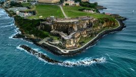 A view of Fort San Felipe del Morro along Caribbean blue waters, Old San Juan, twilight Aerial Stock Photos | AX104_084.0000000F
