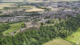 Stirling Castle on a tree covered hill, Scotland Aerial Stock Photos | AX109_037.0000000F