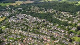 A residential neighborhood with trees in Stirling, Scotland Aerial Stock Photos | AX109_056.0000000F