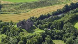 Historic Doune Castle beside a river in Scotland Aerial Stock Photos | AX109_066.0000137F