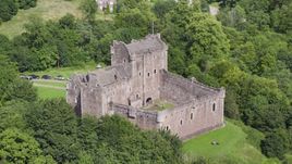 Doune Castle with tourists on the grounds, Scotland Aerial Stock Photos | AX109_071.0000000F