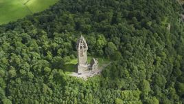 The iconic Wallace Monument surrounded by trees on Abbey Craig, Scotland Aerial Stock Photos | AX109_100.0000080F