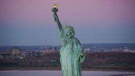 Statue of Liberty with purple sky at sunrise, New York Aerial Stock Photos | AX118_050.0000000F