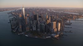 Battery Park and Lower Manhattan skyscrapers at sunrise, New York City Aerial Stock Photos | AX118_086.0000165F