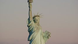 The front of the Statue of Liberty at sunrise in New York Aerial Stock Photos | AX118_107.0000082F