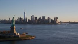 The Statue of Liberty and Lower Manhattan skyline at sunrise in New York Aerial Stock Photos | AX118_122.0000202F