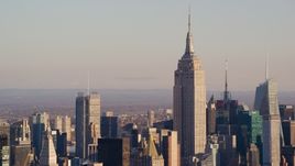 The Empire State Building in Midtown Manhattan at sunrise in New York City Aerial Stock Photos | AX118_174.0000088F