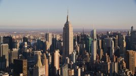 The Empire State Building and surrounding Midtown high-rises at sunrise in New York City Aerial Stock Photos | AX118_178.0000099F