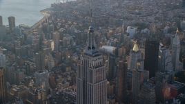 The spire on top of the Empire State Building at sunrise in Midtown Manhattan, New York City Aerial Stock Photos | AX118_204.0000082F