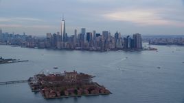 The Lower Manhattan skyline at sunset, New York City, seen from Ellis Island Aerial Stock Photos | AX121_014.0000000F