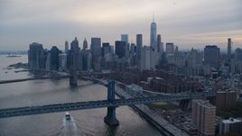 The Brooklyn Bridge, Manhattan Bridge, and Lower Manhattan at sunset in New York City Aerial Stock Photos | AX121_029.0000120F
