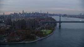 Lower East Side projects, the Williamsburg Bridge, and Midtown skyline at sunset in New York City Aerial Stock Photos | AX121_044.0000009F