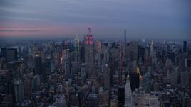 Empire State Building with pink lights and Midtown high-rises at Sunset in New York City Aerial Stock Photos | AX121_081.0000239F