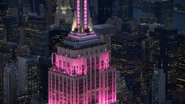 Empire State Building with pink lighting at sunset in Midtown Manhattan, New York City Aerial Stock Photos | AX121_109.0000095F