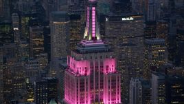 Pink lights on the Empire State Building at sunset in Midtown Manhattan, New York City Aerial Stock Photos | AX121_109.0000359F