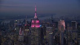 Pink lights on the Empire State Building at sunset in Midtown Manhattan, New York City Aerial Stock Photos | AX121_111.0000100F