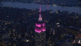 The Empire State Building with pink lights at sunset in Midtown, New York City Aerial Stock Photos | AX121_127.0000132F