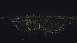 Lower Manhattan at night, seen from New York Harbor in New York City Aerial Stock Photos | AX121_194.0000066F