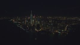 Lower Manhattan seen from New York Harbor at night in New York City Aerial Stock Photos | AX121_194.0000179F