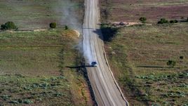 Silver SUV trailing a plume of dust on Hatch Point Road, Moab, Utah Aerial Stock Photos | AX138_223.0000047