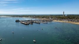 Boats docked at piers beside a small coastal town, Provincetown, Massachusetts Aerial Stock Photos | AX143_222.0000000