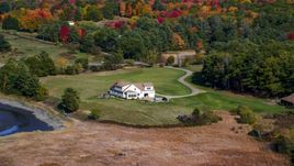 An isolated home and colorful autumn trees, Newcastle, Maine Aerial Stock Photos | AX148_011.0000000