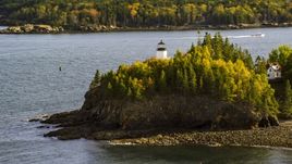 Owls Head Light beside the water and trees with fall foliage, autumn, Owls Head, Maine Aerial Stock Photos | AX148_084.0000022