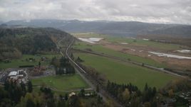 A train traveling by fields and country road in Washougal, Washington Aerial Stock Photos | AX153_177.0000000F