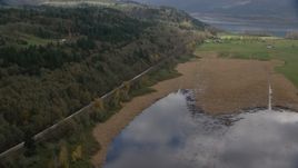 A train traveling by fields and water in Washougal, Washington Aerial Stock Photos | AX153_178.0000113F