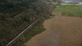 A train traveling by fields and water in Washougal, Washington Aerial Stock Photos | AX153_178.0000352F