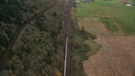 A train traveling past open fields in Washougal, Washington Aerial Stock Photos | AX153_179.0000261F