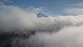 Mount Hood, visible above a layer of thick clouds, Cascade Range, Oregon Aerial Stock Photos | AX154_060.0000000F