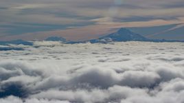Mount Jefferson and the Three Sisters Volcanoes seen from across low clouds, Cascade Range, Oregon Aerial Stock Photos | AX154_098.0000218F