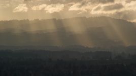 Godrays shining down on mountains near Beaverton, Oregon at sunset Aerial Stock Photos | AX155_124.0000225F