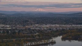 Mount Hood in the far distance at sunset, seen from a train yard in Southeast Portland, Oregon Aerial Stock Photos | AX155_169.0000000F