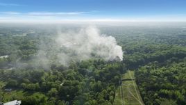 Smoke rising from a house fire in a wooded area, West Atlanta, Georgia Aerial Stock Photos | AX38_048.0000129F