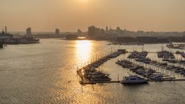 Downtown Baltimore skyline at sunset, seen from Baltimore Marine Center, Maryland Aerial Stock Photos | AXP073_000_0022F