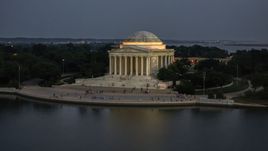 The front of the Jefferson Memorial lit up for the night, Washington, D.C., twilight Aerial Stock Photos | AXP076_000_0036F