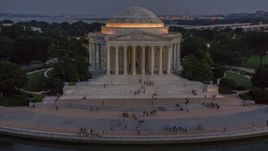 Visitors at the Jefferson Memorial, lit up at twilight in Washington, D.C. Aerial Stock Photos | AXP076_000_0037F