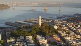 Coit Tower with Bay Bridge in background, North Beach, San Francisco, California, sunset Aerial Stock Photos | DCSF07_008.0000069
