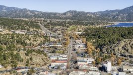Shops on a road through town, with mountains and Lake Estes in the background, Estes Park, Colorado Aerial Stock Photos | DXP001_000226