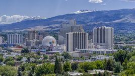Hotels and casinos with mountains in the background in Reno, Nevada Aerial Stock Photos | DXP001_004_0004