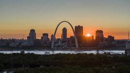 Aerial stock photo of the Gateway Arch and the Downtown St. Louis, Missouri skyline in silhouette at sunset Aerial Stock Photos | DXP001_029_0008