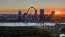 The setting sun, the Gateway Arch and Downtown St. Louis, Missouri skyline Aerial Stock Photos | DXP001_029_0010