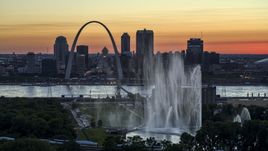 The Gateway Geyser with the Arch in the background, Downtown St. Louis, Missouri, twilight Aerial Stock Photos | DXP001_030_0002