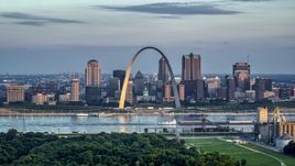 A view of the Gateway Arch by the Mississippi River at sunrise in Downtown St. Louis, Missouri Aerial Stock Photos | DXP001_038_0004